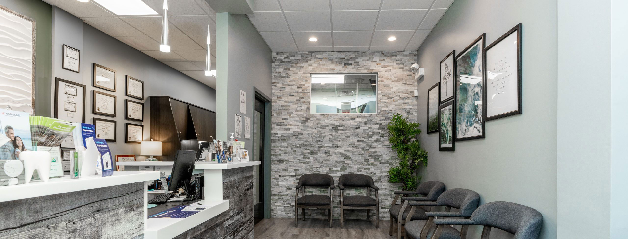 The image shows a modern dental clinic interior with various pieces of equipment, including a dental chair and an X-ray machine.